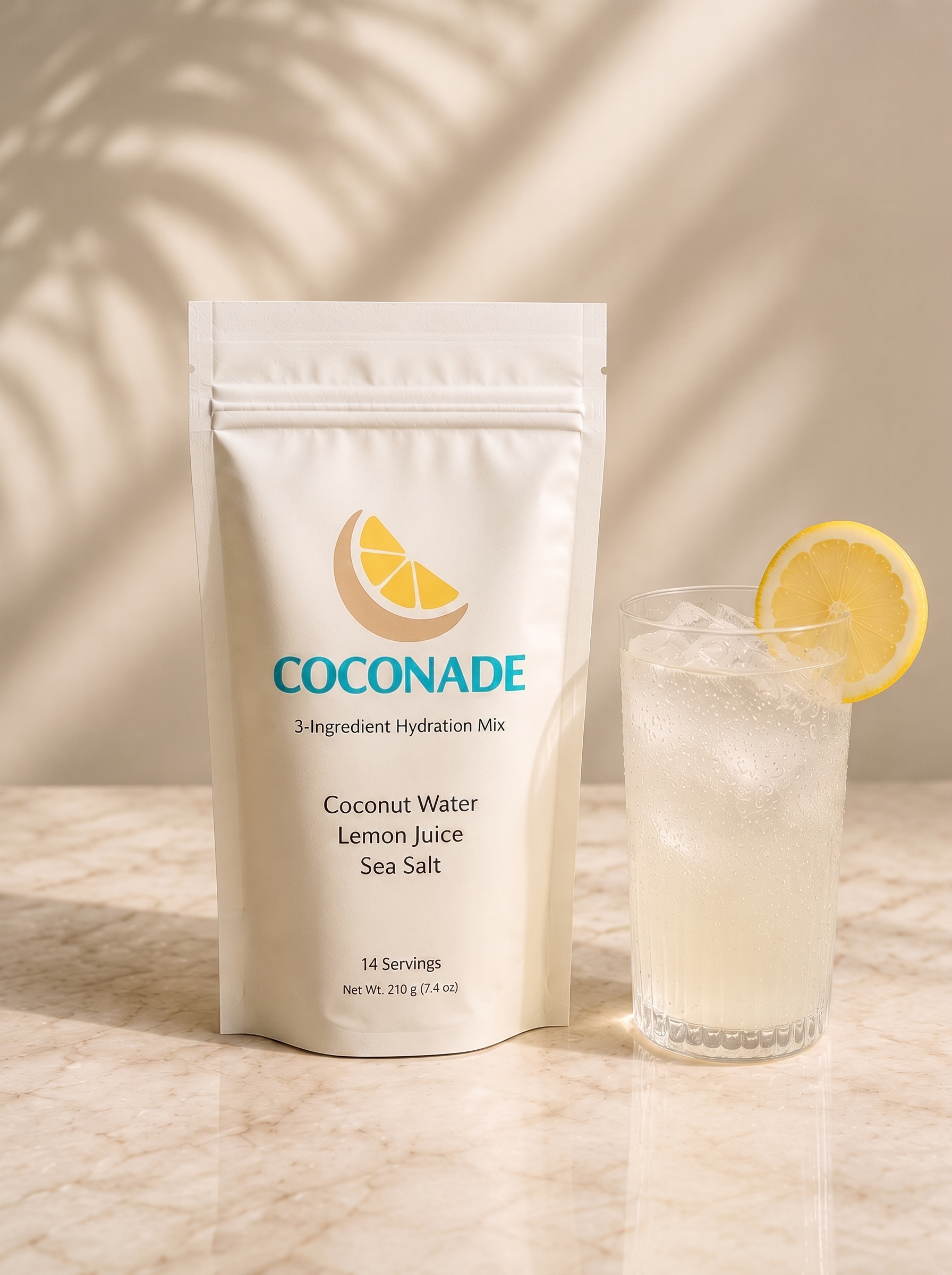 Coconade 14-serving pouch of 3-ingredient hydration mix beside a glass of iced coconut lemonade